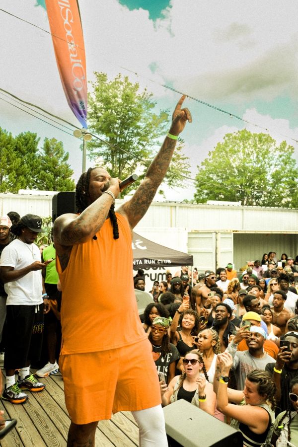 A runner clapping in the crowd after the run
